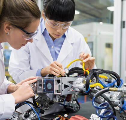 Women engineers working on device